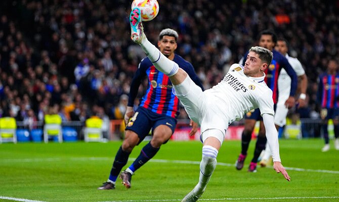 Federico Valverde toca la pelota ante Ronald Araujo en el clasico entre Real Madrid y Barcelona